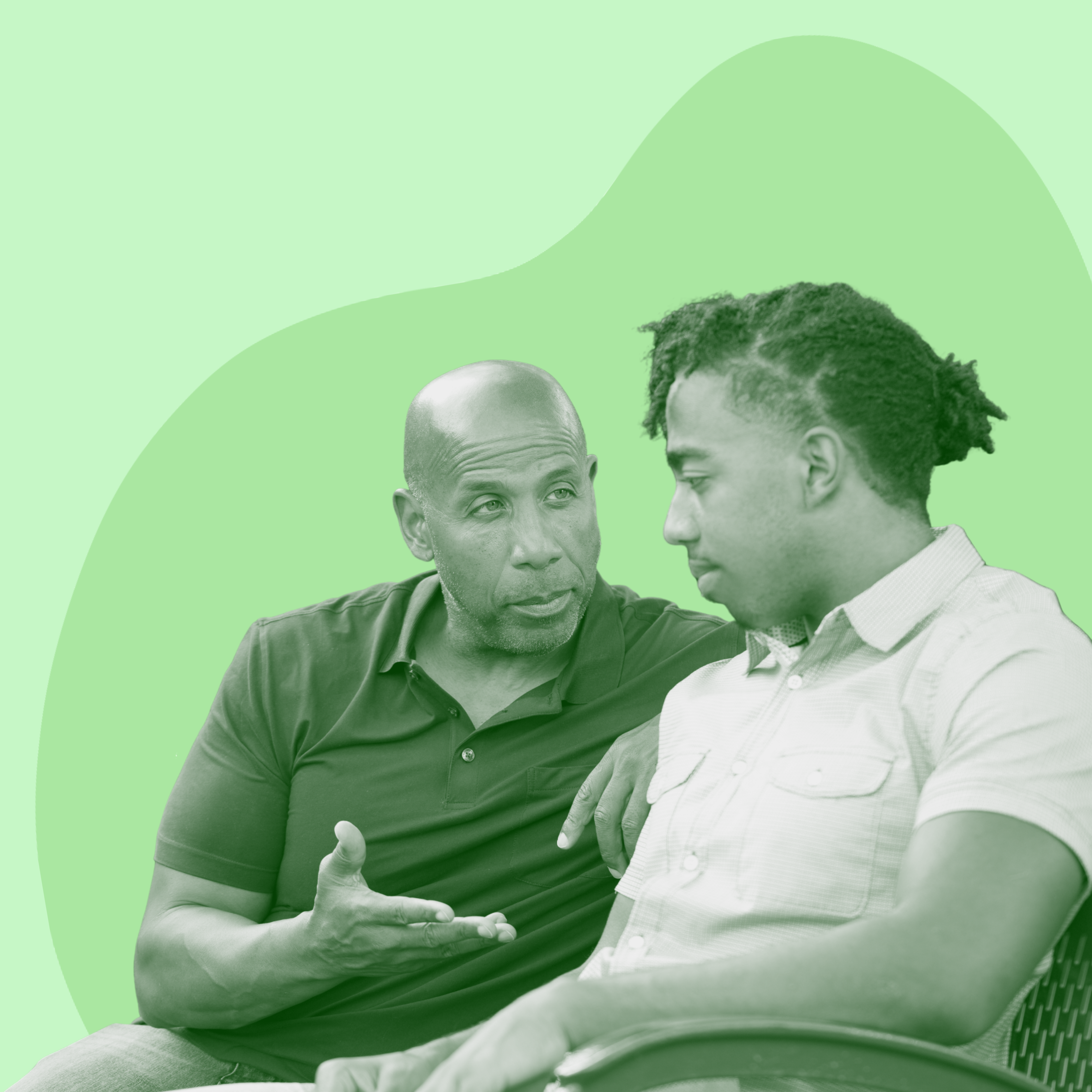 Two people sitting together, one speaking while the other listens attentively